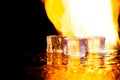 three ice cubes against the background of fire, fire and ice, place under the text Royalty Free Stock Photo