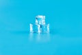 Three ice cubes on a blue background in meltwater Royalty Free Stock Photo
