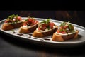 three identical bruschettas on a modern plate, glaze in tiny droplets