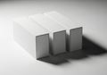 Three identical white rectangular blocks casting long shadows on a textured surface in monochrome lighting Royalty Free Stock Photo