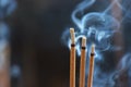 Smouldering incense sticks, burning and smoking Royalty Free Stock Photo