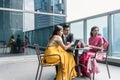 Three Indian business people talking during break at work