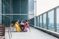 Three Indian business people talking during break at work