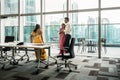 Three Indian employees talking during break in the meeting room