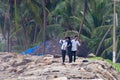 Three Indian men on the beach in fishing village Royalty Free Stock Photo