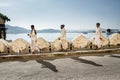 Three indian men walk equidistant to each other, Udaipur Palace