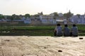 Pushkar, India - August 21, 2009: three Indians sitting on the shore of dry lake in Pushkar, India