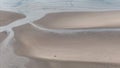 people riding horses across a beach by the ocean in low tide Royalty Free Stock Photo