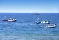 three Indonesian fishing boats are fishing in the middle of the sea