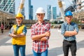 Three Industrial engineer wear safety helmet engineering standing with arms crossed on building outside.