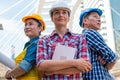 Three Industrial engineer wear safety helmet engineering standing with arms crossed on building outside.