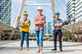 Three Industrial engineer wear safety helmet engineering standing with arms crossed holding inspection tablet and smile