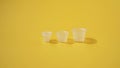 Three ink plastic caps on yellow background Royalty Free Stock Photo