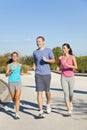 Three Interracial Adult Friends Running Jogging