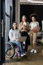 three interracial businesswomen, happy disabled woman Royalty Free Stock Photo