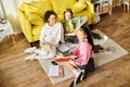 Three interracial teenage girls sit on Royalty Free Stock Photo