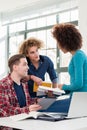 Three involved students sharing ideas and opinions about different topics Royalty Free Stock Photo