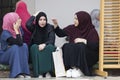 Three islamic girls sit in the courtyard of Gazi husrev beg Mosque in Sarajevo