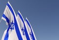 Three Israeli flags on flagpoles on a blue background. Place for text. Flags flutter in wind. Israeli. Jerusalem. 3d illustration Royalty Free Stock Photo