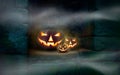 Three Jack O` Lanterns on a stone cut out in the ruins of an old monastery