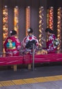 Three Japanese Women sitting in Kimonos