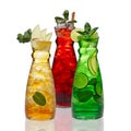 Three jar with icy drinks - apple, cherry and lemon on white background with reflection