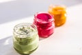 Three jars of colorful jams. Green red and yeallow honey souffle Royalty Free Stock Photo