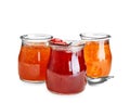 Three jars with tasty sweet jam on white background Royalty Free Stock Photo