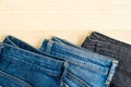 Three jeans denim on wood background