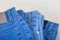 Three jeans in different blue shades on a light background.Selective focus.Concept of denim texture clothing wardrobe selection