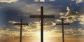 Three Jesus Christ christian crucifixes or crosses backlit from sunset or sunrise sky with clouds, god, resurrection, easter or Royalty Free Stock Photo