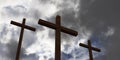 Three Jesus Christ christian crucifixes or crosses in front of stormy sky with dark clouds, god, resurrection or christianity