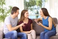 Three joyful friends talking on a couch at home Royalty Free Stock Photo