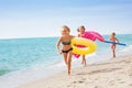 Joyful girls in swimwear running at tropical beach Royalty Free Stock Photo