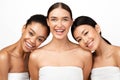 Three Joyful Models Posing Wrapped In Towels On White Background