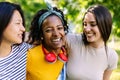 Three joyful multiracial young teenage girls having fun together outdoors