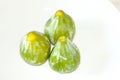 Three organic fresh green figs, on white background, from above Royalty Free Stock Photo