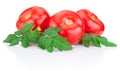 Three juicy red tomato with leaves on white