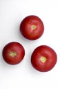 Three juicy red tomatoes on a white background Royalty Free Stock Photo