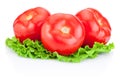Three juicy tomatoes with green leaves lettuce isolated