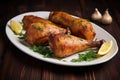 three juicy turkey drumsticks in a smoky marinade on a serving plate