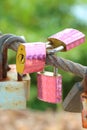 Three key cover with pink sticker and many old rust key lock with rust iron fence