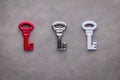 Three keys red silver and white on grey background Royalty Free Stock Photo