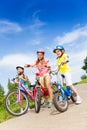 Three kid girls holding bicycles outdoors Royalty Free Stock Photo