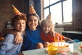 Three kids celebrating bday and looking happy