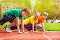 Three kids close-up in uniforms ready to run Royalty Free Stock Photo