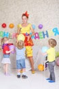 Three kids and facilitator play with balloons at