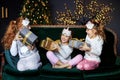 Three kids girls holding presents surprises for Christmas. The concept of Merry Christmas, holidays, New Year, family and gifts Royalty Free Stock Photo