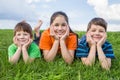 Three kids on green meadow