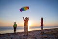 Kids launching the rainbow kite together Royalty Free Stock Photo